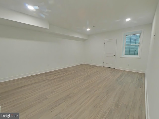 basement with light hardwood / wood-style flooring