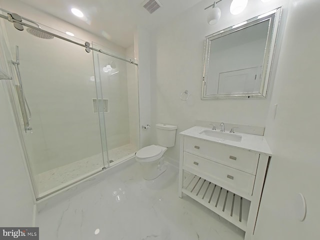 bathroom featuring vanity, an enclosed shower, and toilet