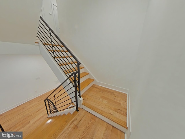 stairs featuring hardwood / wood-style flooring