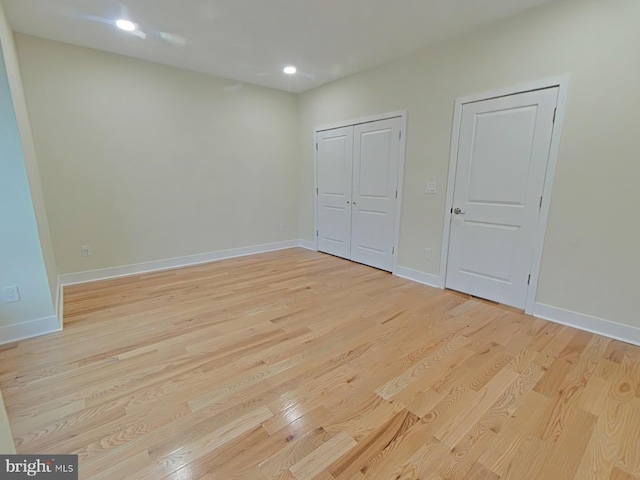 unfurnished bedroom with light wood-type flooring