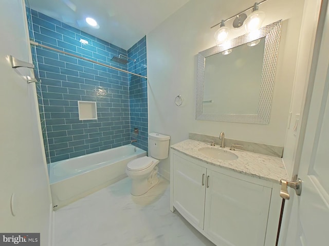 full bathroom featuring vanity, tiled shower / bath combo, and toilet