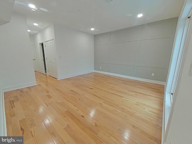 spare room with light hardwood / wood-style flooring