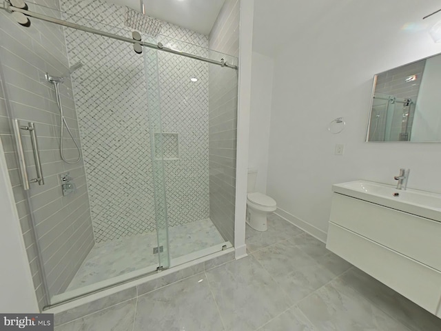 bathroom featuring vanity, an enclosed shower, and toilet