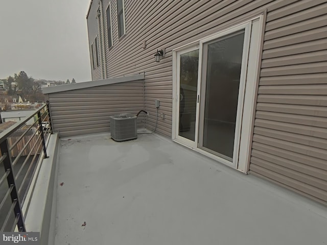 view of patio / terrace with central AC unit and a balcony