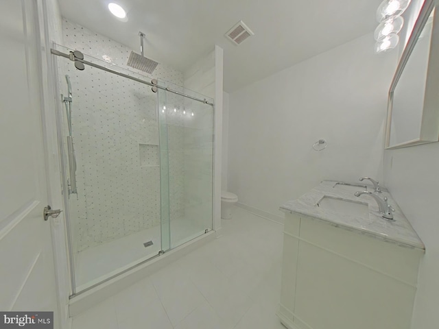 bathroom featuring vanity, toilet, and walk in shower