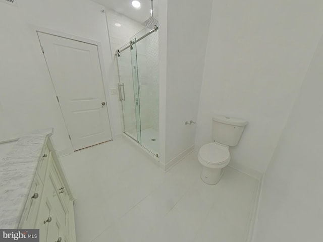 bathroom with a shower with door, tile patterned flooring, and toilet