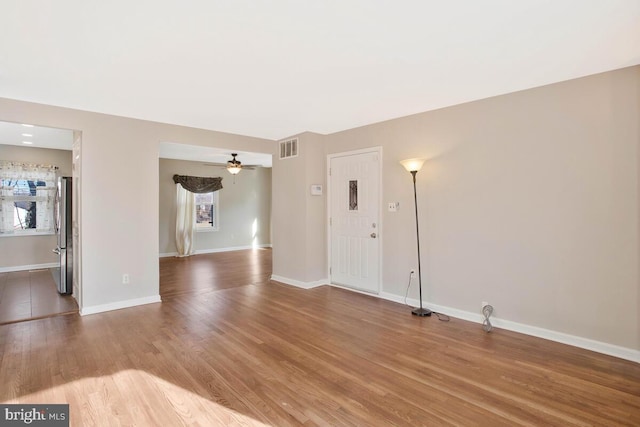 unfurnished room with hardwood / wood-style floors and ceiling fan