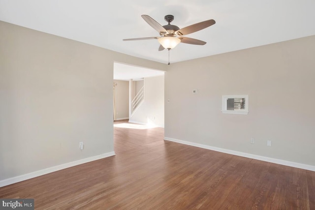 spare room with hardwood / wood-style flooring and ceiling fan