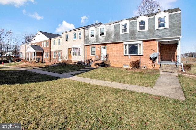 townhome / multi-family property featuring a front yard