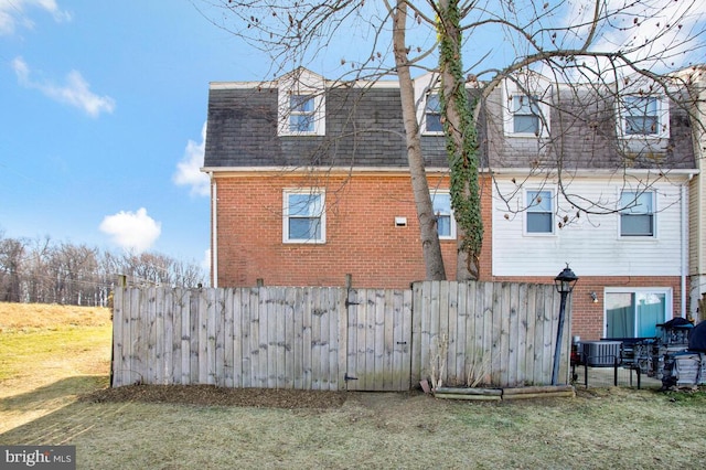 back of house featuring a yard and cooling unit