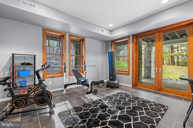 workout area with tile patterned flooring, baseboards, french doors, and visible vents