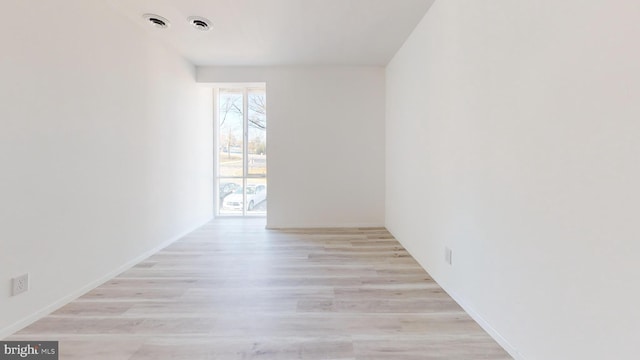 empty room with light hardwood / wood-style flooring