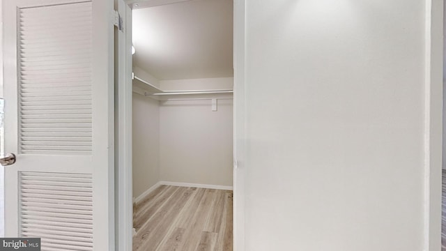 walk in closet featuring light hardwood / wood-style flooring