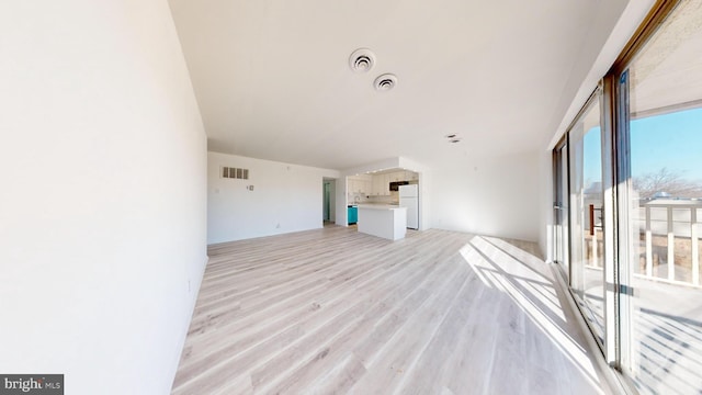 unfurnished living room featuring light wood-type flooring