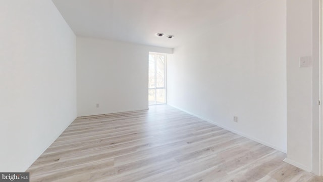 unfurnished room with light wood-type flooring