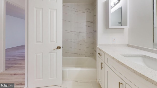 bathroom featuring vanity and tiled shower / bath combo