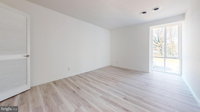 spare room featuring light wood-type flooring