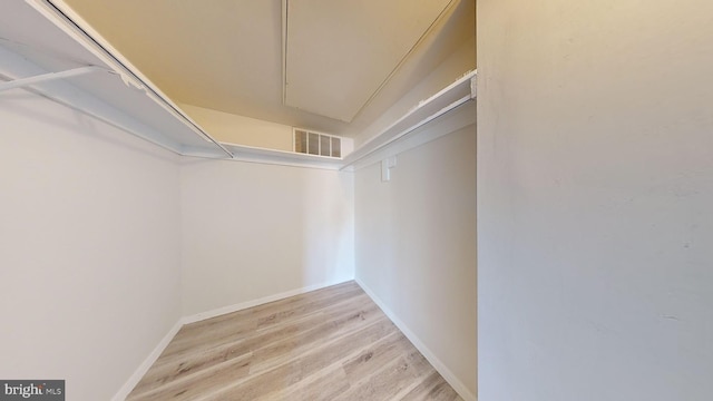 spacious closet with light hardwood / wood-style floors