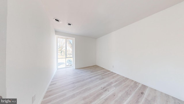 unfurnished room with light hardwood / wood-style floors