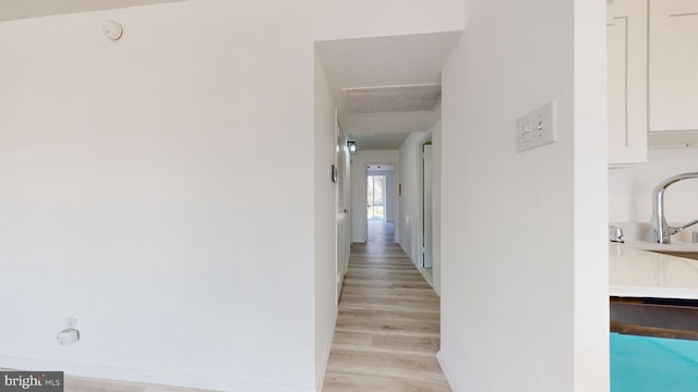 corridor with light wood-type flooring