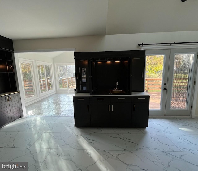 unfurnished living room featuring french doors and sink