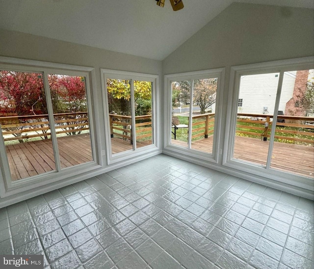 unfurnished sunroom with vaulted ceiling and ceiling fan