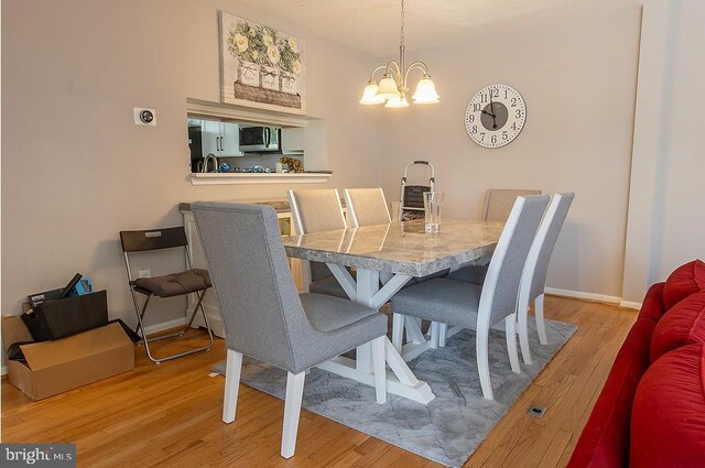 5310 Kelmscot Rd, Rosedale, MD 21237 - dining room featuring baseboards, an inviting chandelier, and light wood-style flooring