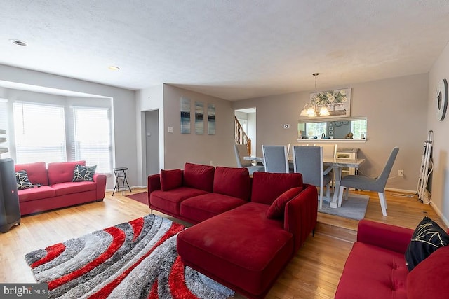 5310 Kelmscot Rd, Rosedale, MD 21237 - living room with stairs, baseboards, a notable chandelier, and wood finished floors