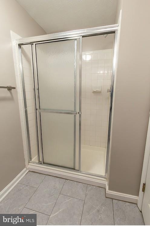 5310 Kelmscot Rd, Rosedale, MD 21237 - full bathroom featuring baseboards, tile patterned floors, and a stall shower