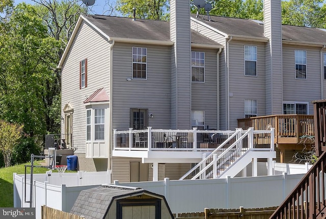 5310 Kelmscot Rd, Rosedale, MD 21237 - rear view of house featuring stairway, a chimney, a fenced backyard, and a wooden deck