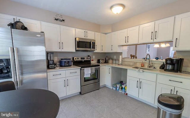 5310 Kelmscot Rd, Rosedale, MD 21237 - kitchen with light countertops, white cabinets, appliances with stainless steel finishes, and a sink