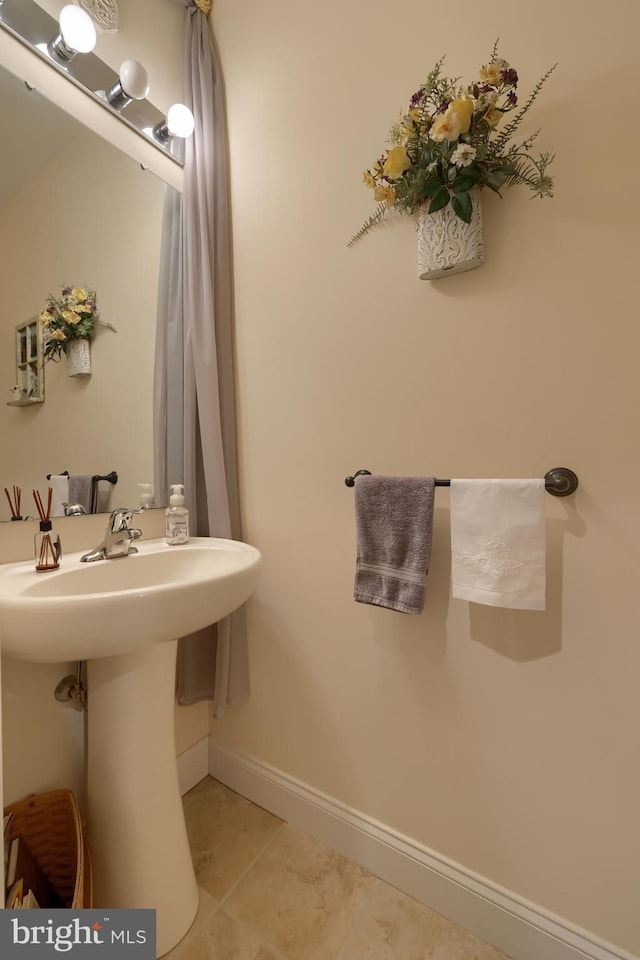 bathroom with tile patterned flooring and baseboards