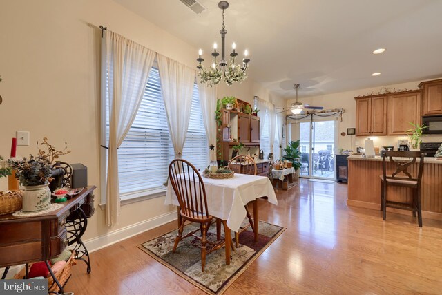 dining space featuring recessed lighting, visible vents, light wood-style flooring, an inviting chandelier, and baseboards