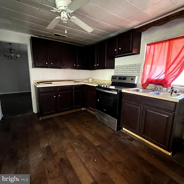 kitchen featuring stainless steel electric stove, dark brown cabinets, sink, and dark wood-type flooring