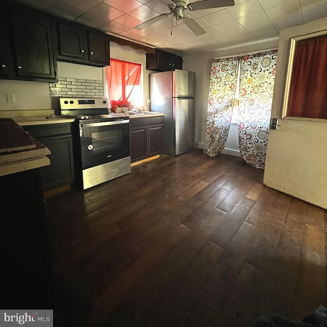 kitchen featuring tasteful backsplash, ceiling fan, dark hardwood / wood-style flooring, and stainless steel appliances