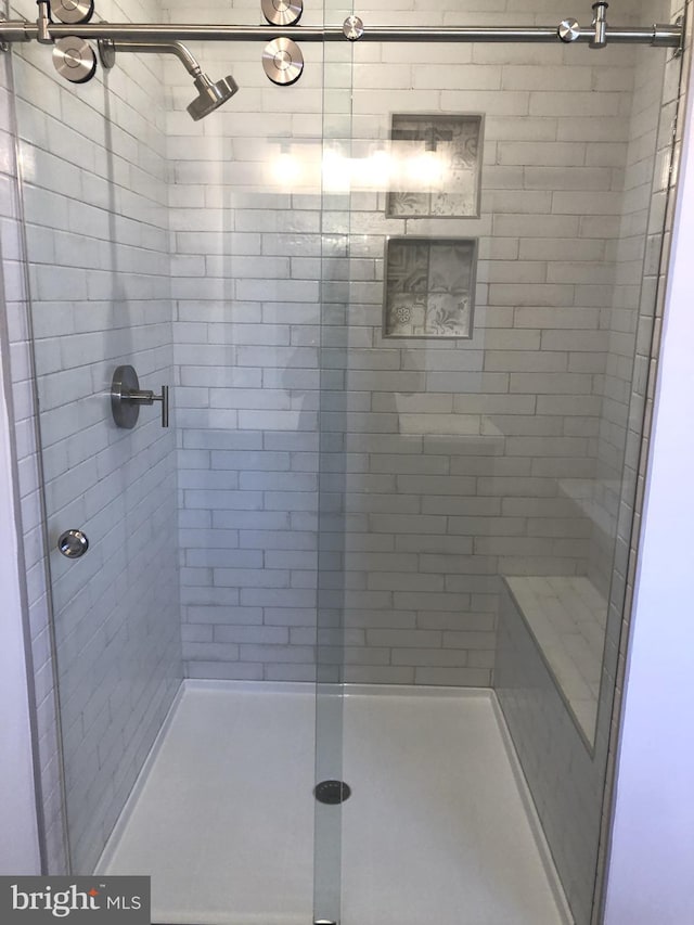 bathroom with a shower with shower door