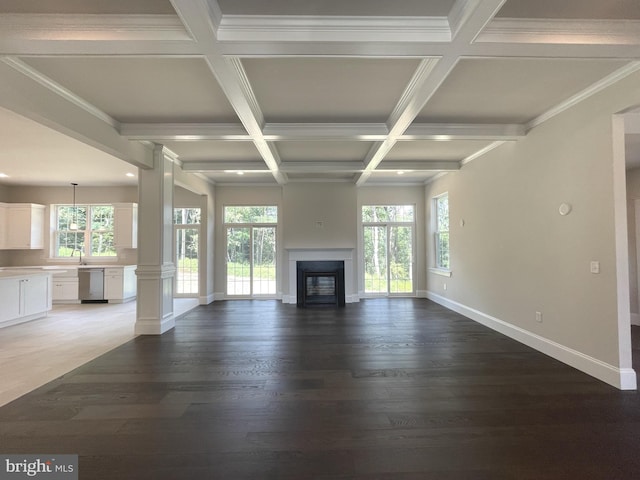 unfurnished living room with beamed ceiling, ornamental molding, dark wood-type flooring, and coffered ceiling