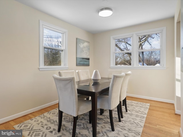 dining space with light hardwood / wood-style floors