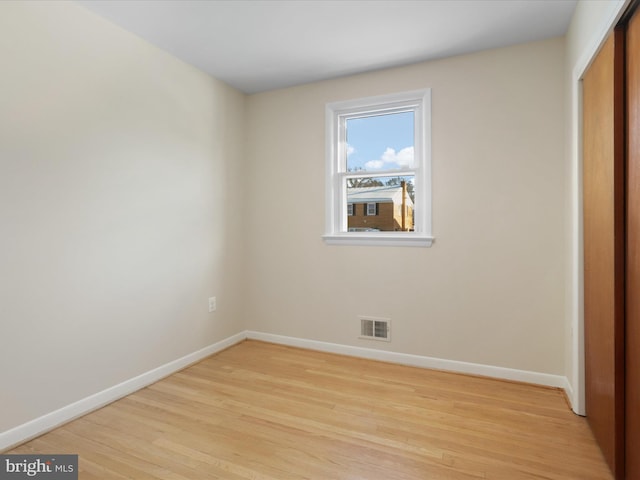 unfurnished bedroom with light hardwood / wood-style floors and a closet