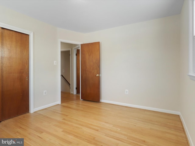 unfurnished bedroom featuring a closet and light hardwood / wood-style floors