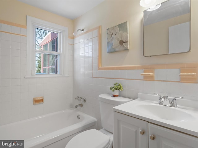 full bathroom with vanity, toilet, tile walls, and tiled shower / bath combo