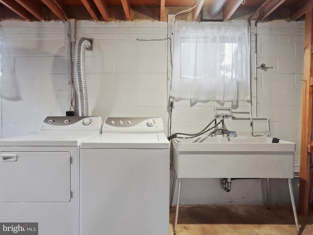 laundry area featuring washing machine and dryer and sink