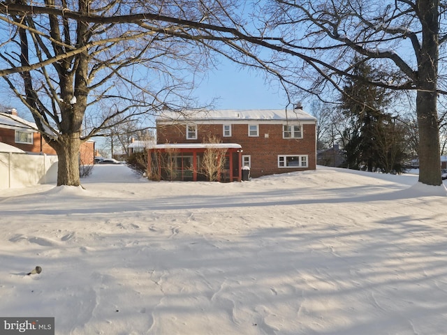 view of snow covered rear of property