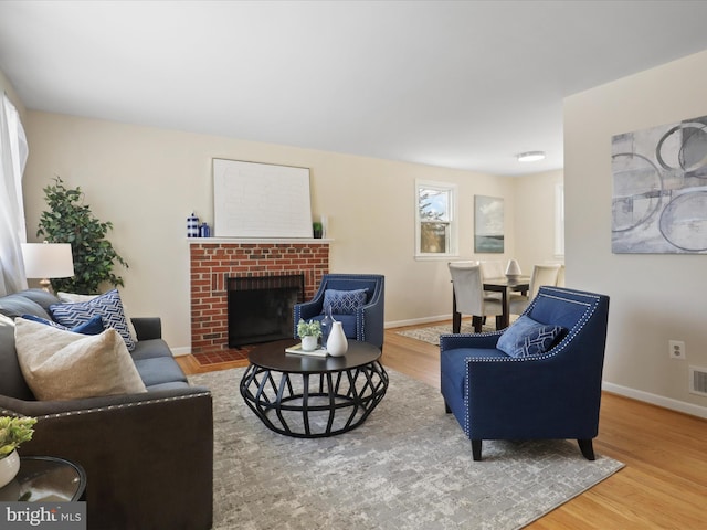 living room with hardwood / wood-style floors and a fireplace