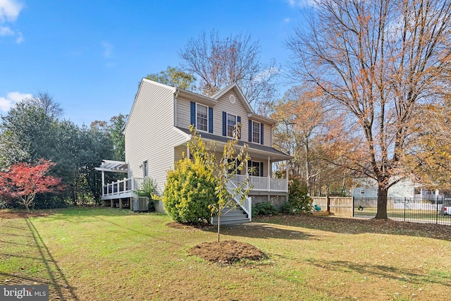 view of side of property with a pergola, a yard, and central AC