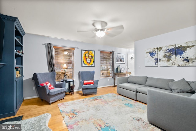 living room featuring ceiling fan and light wood-type flooring