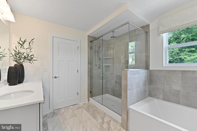 bathroom with vanity, a textured ceiling, and independent shower and bath