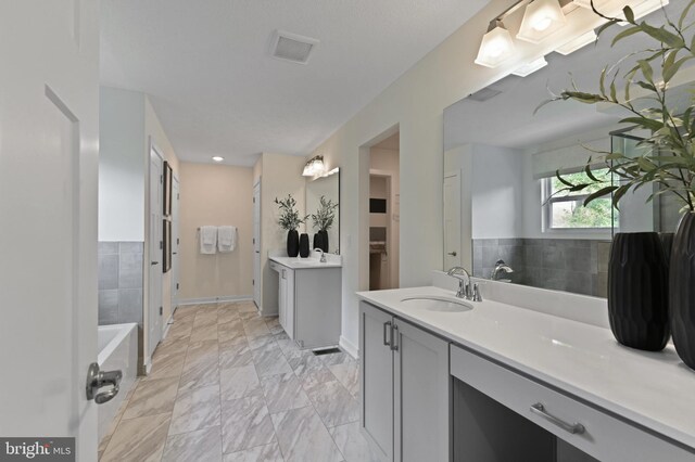 8 Timberidge Dr, Fredericksburg, VA 22406 - bathroom with vanity, a bath, a closet, and baseboards