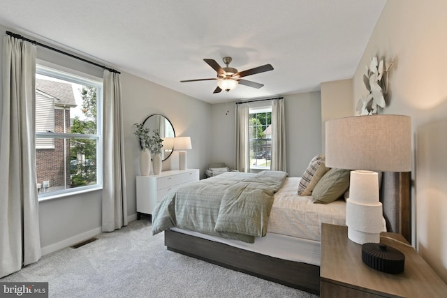 bedroom featuring ceiling fan and light carpet