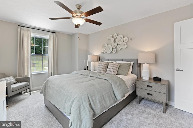 bedroom with ceiling fan and light colored carpet